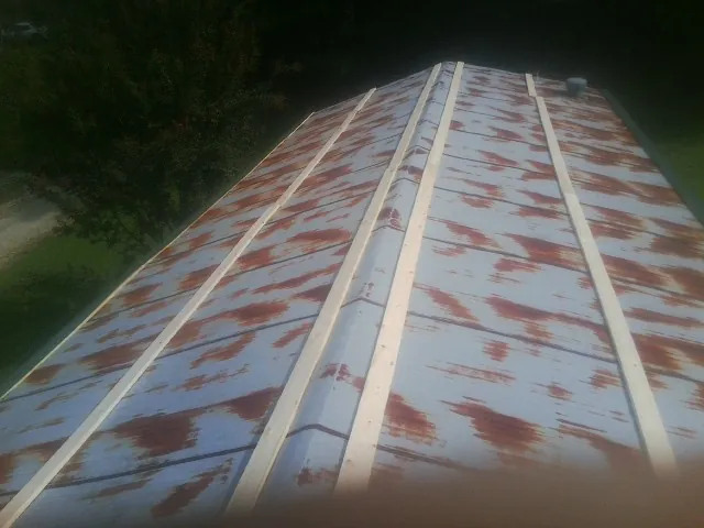 Rusted metal roof panels with new wood purlins before replacement — Storm Damage Roof Repair in Tybee Island by Roofing Brothers